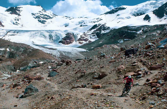 Mountain biker on alpine trails near Santa Caterina Valfurva